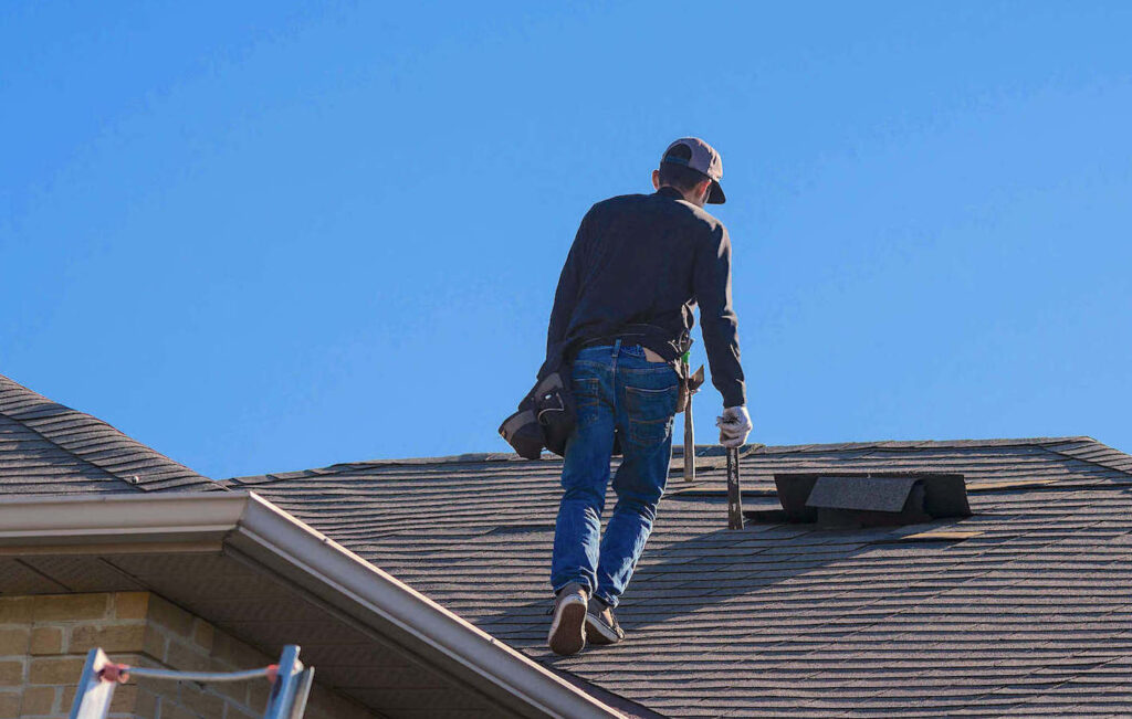 Roofing contractor inspecting storm damage for an insurance claim in Las Vegas
