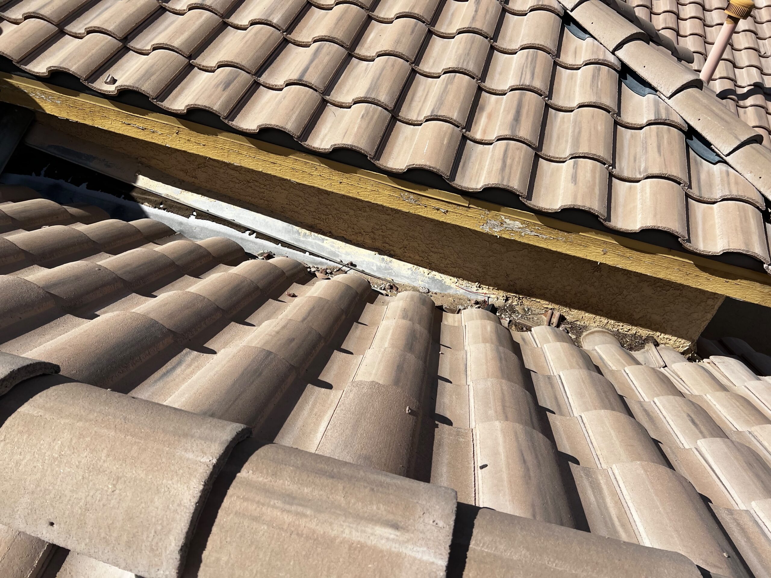 Tile roof repair in Las Vegas 89131 — roof tiles and wall flashing on Jalisco Avenue