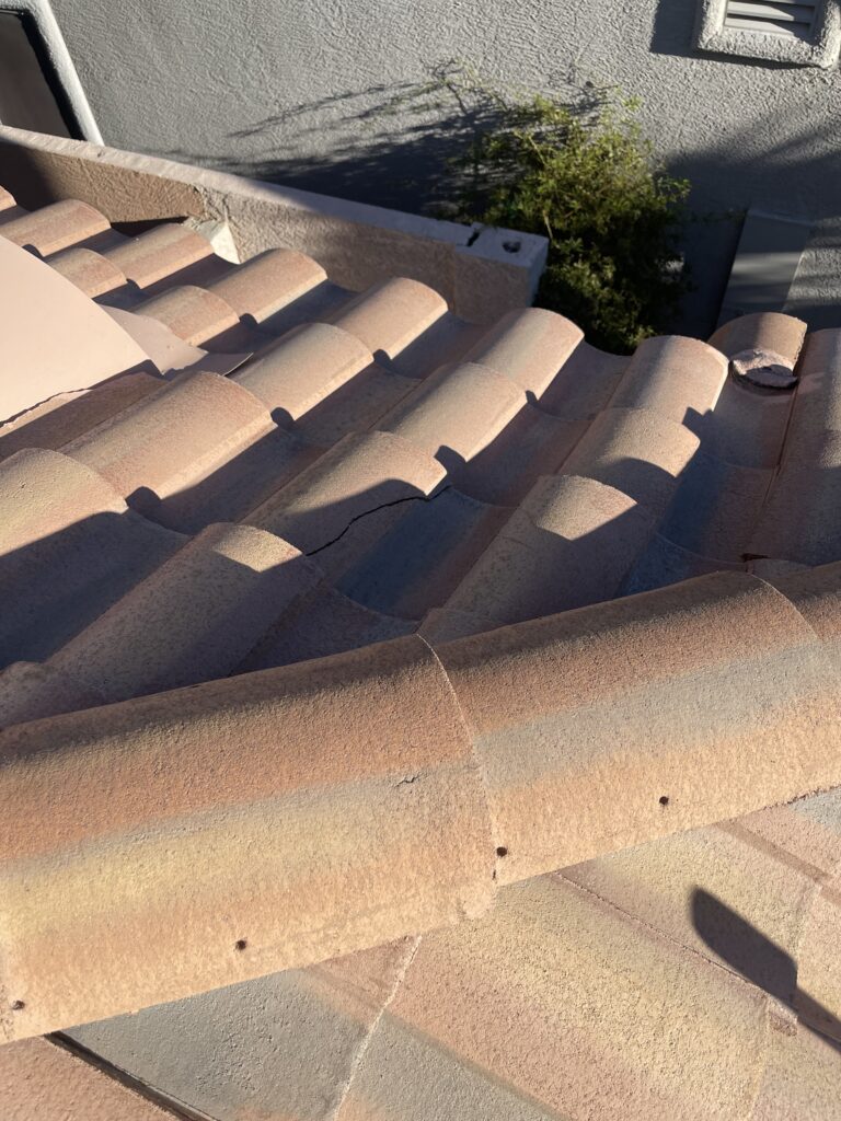 Curved roof tiles with a visible crack near the roof edge