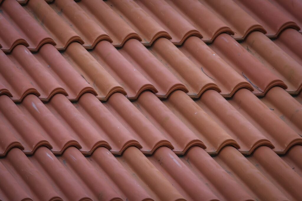 Close-up of overlapping terracotta roof tiles